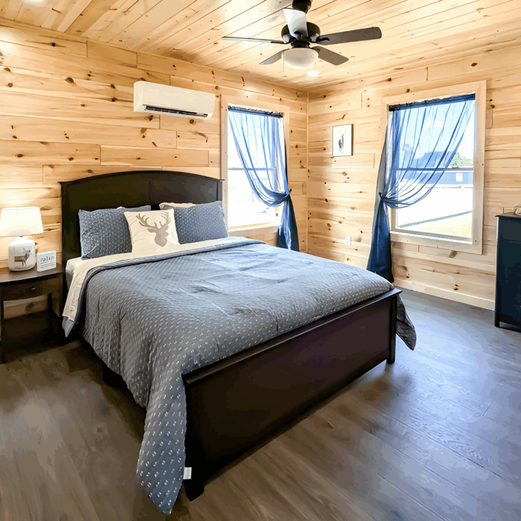 Modular home bedroom with blue accents and pine walls