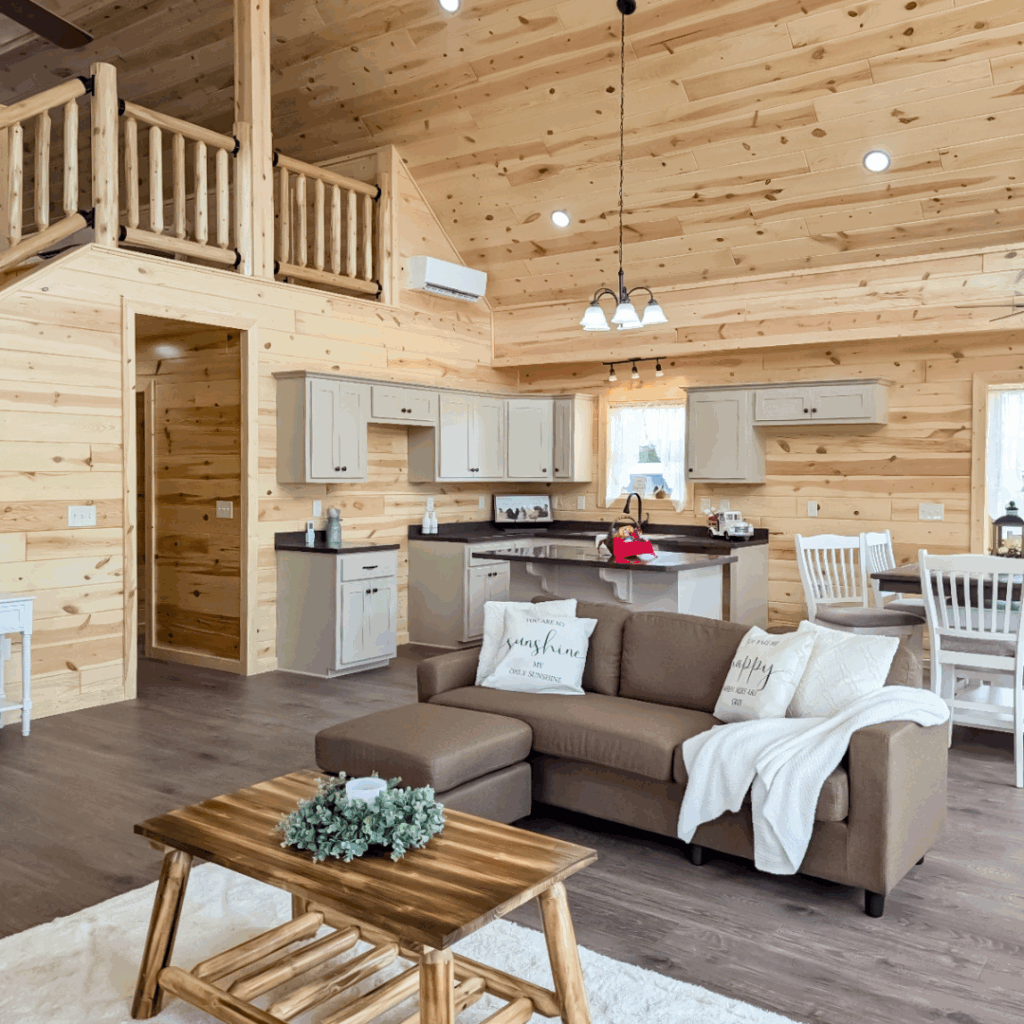 Trophy Peak series living room and kitchen with stairs. Pine interior walls
